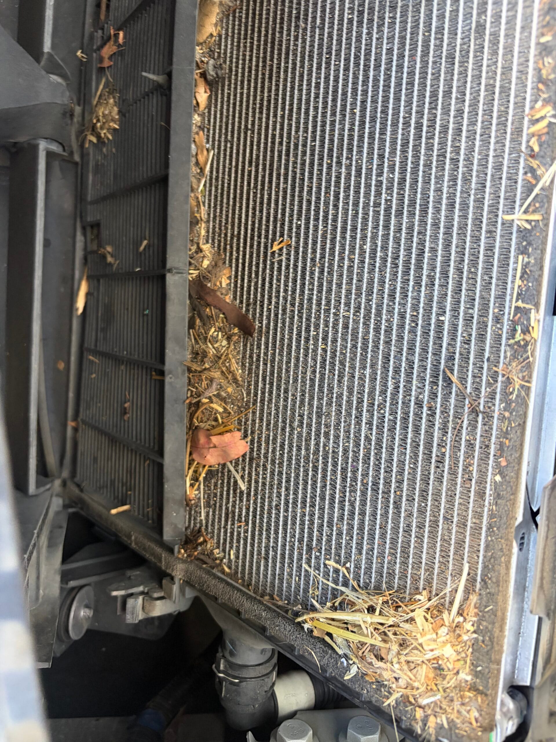 Clogged Tesla Model 3 radiator packed with leaves and debris