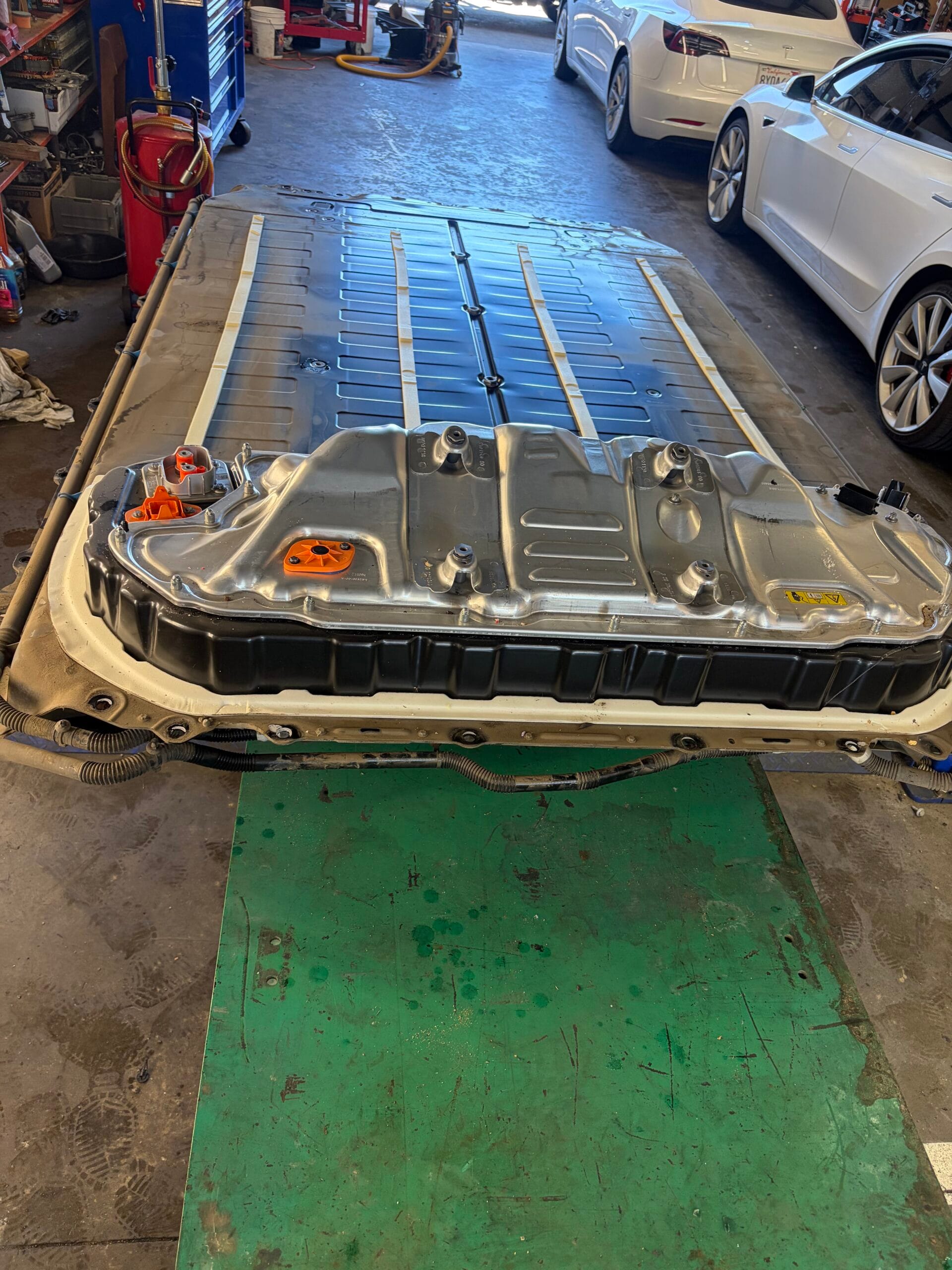Tesla Model 3 high voltage battery pack removed and sitting on shop floor